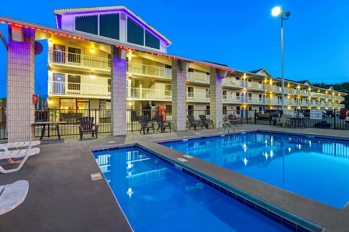 Briarstone Inn outdoor pool at dusk with illuminated balconies